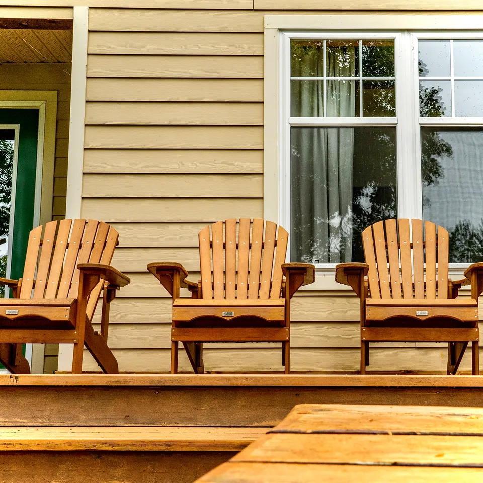 Adirondack chairs arranged on a deck