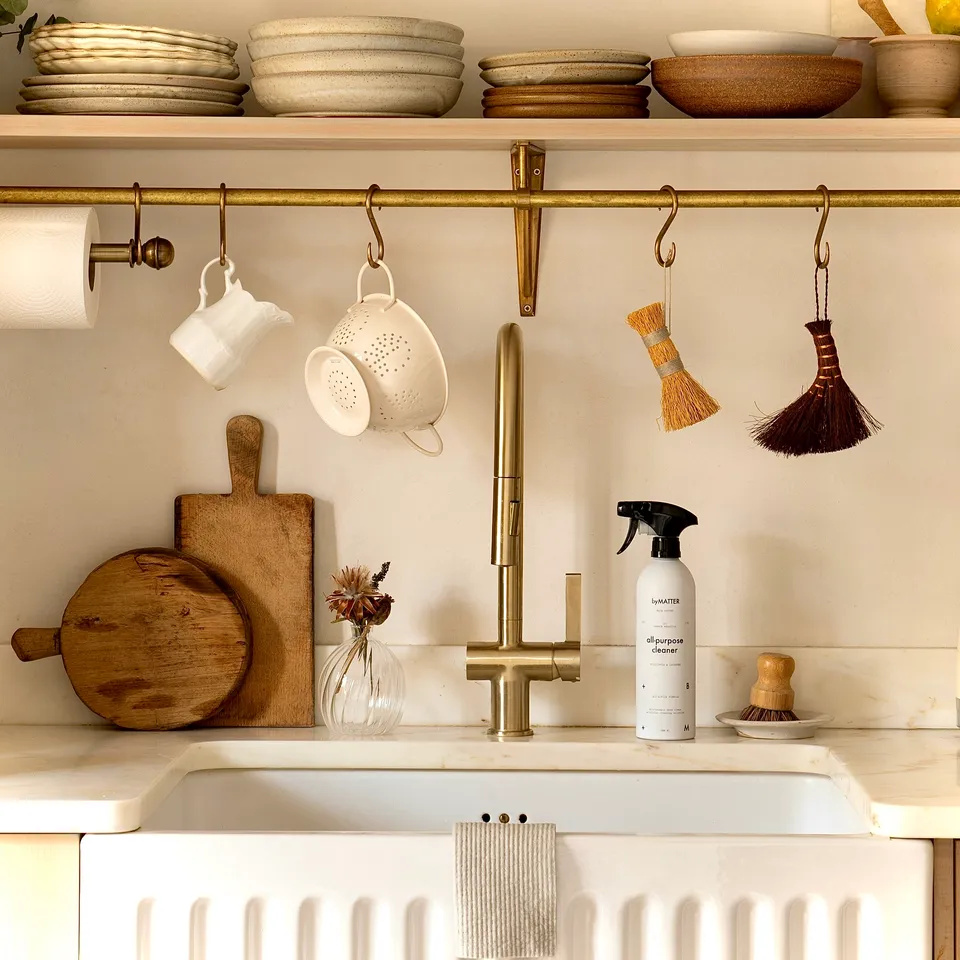 Farmhouse sink with brass faucet and cleaner